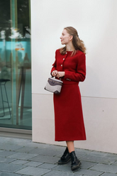 a lady in a red jacket and skirt two-piece set